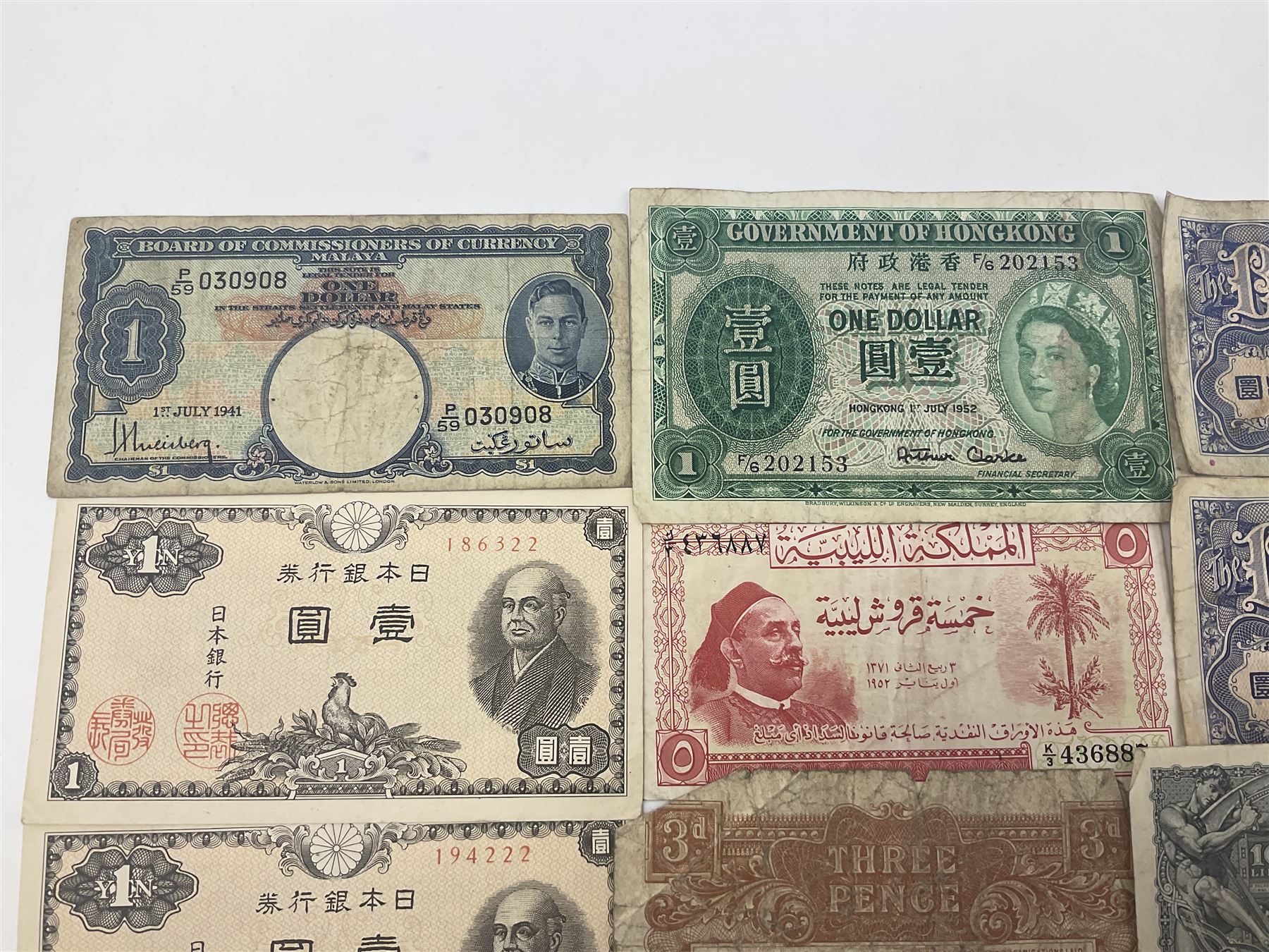 Banknotes including King George VI board of commissioners of currency Malaya one dollar 1st July 1941 'P/59 030908', Queen Elizabeth II Government of Hongkong one dollar 1st July 1952 'F/6 202153' etc