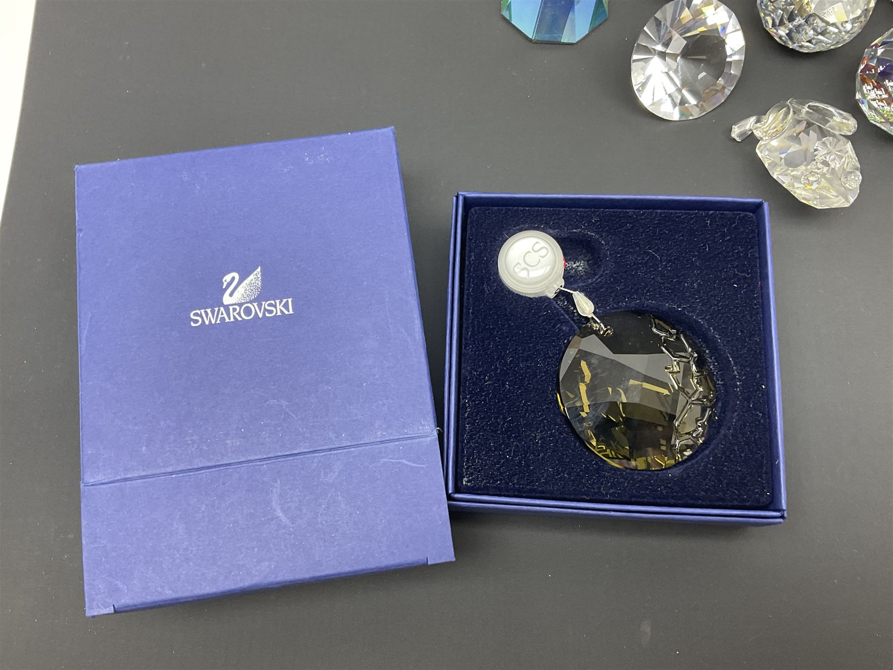 Swarovski Crystal paperweights, to include a globe with dove to the top, pyramid shapes etc, together with a large collection of boxes and stands  