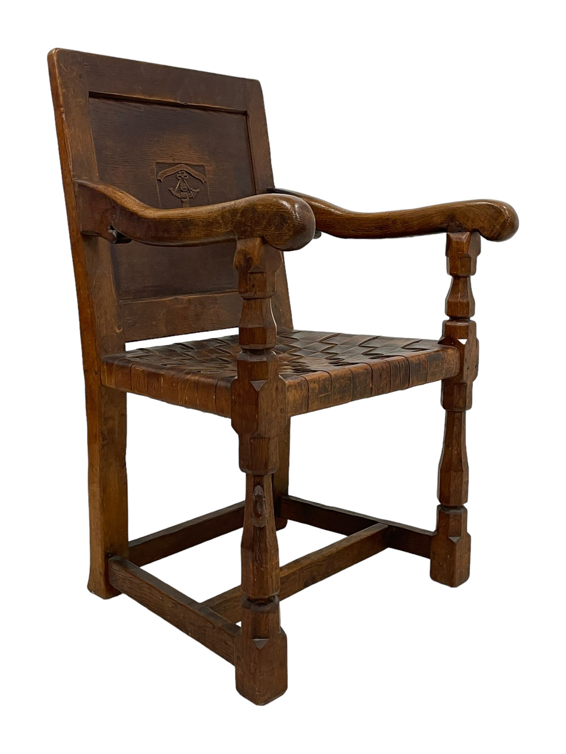 Mouseman - circa. 1930s set of six (4+2) oak dining chairs, panelled back carved with the Bagshawe family crest, the moto 'Forma Flos Fama Flatus' over an arm grasping a bugle-horn with ribbon tie and Yorkshire rose motif, adzed frame, leather lattice strap seat, on octagonal supports united by stretchers, two carvers and four side chairs, each carved with mouse signature, by Robert Thompson of Kilburn 

Provenance: Owned since manufacture by the Bagshawe family, descendants of the Staithes Group Artist Joseph Richard Bagshawe RBA (1870-1909).