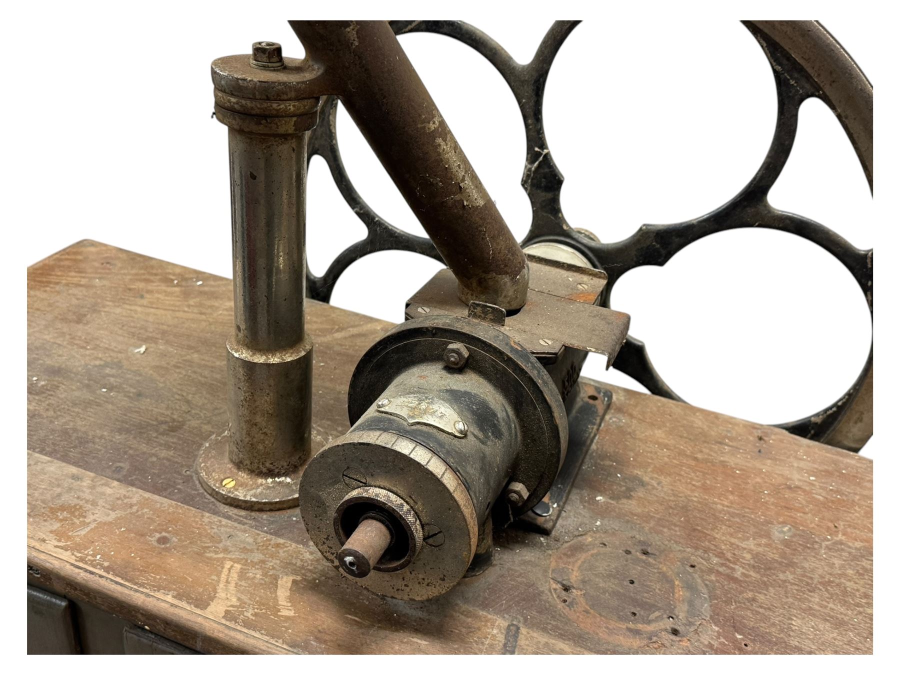Cabinet with multiple drawers and cupboards mounted with two industrial coffee grinders with large flywheels and brass coffee reservoirs, early 20th century 