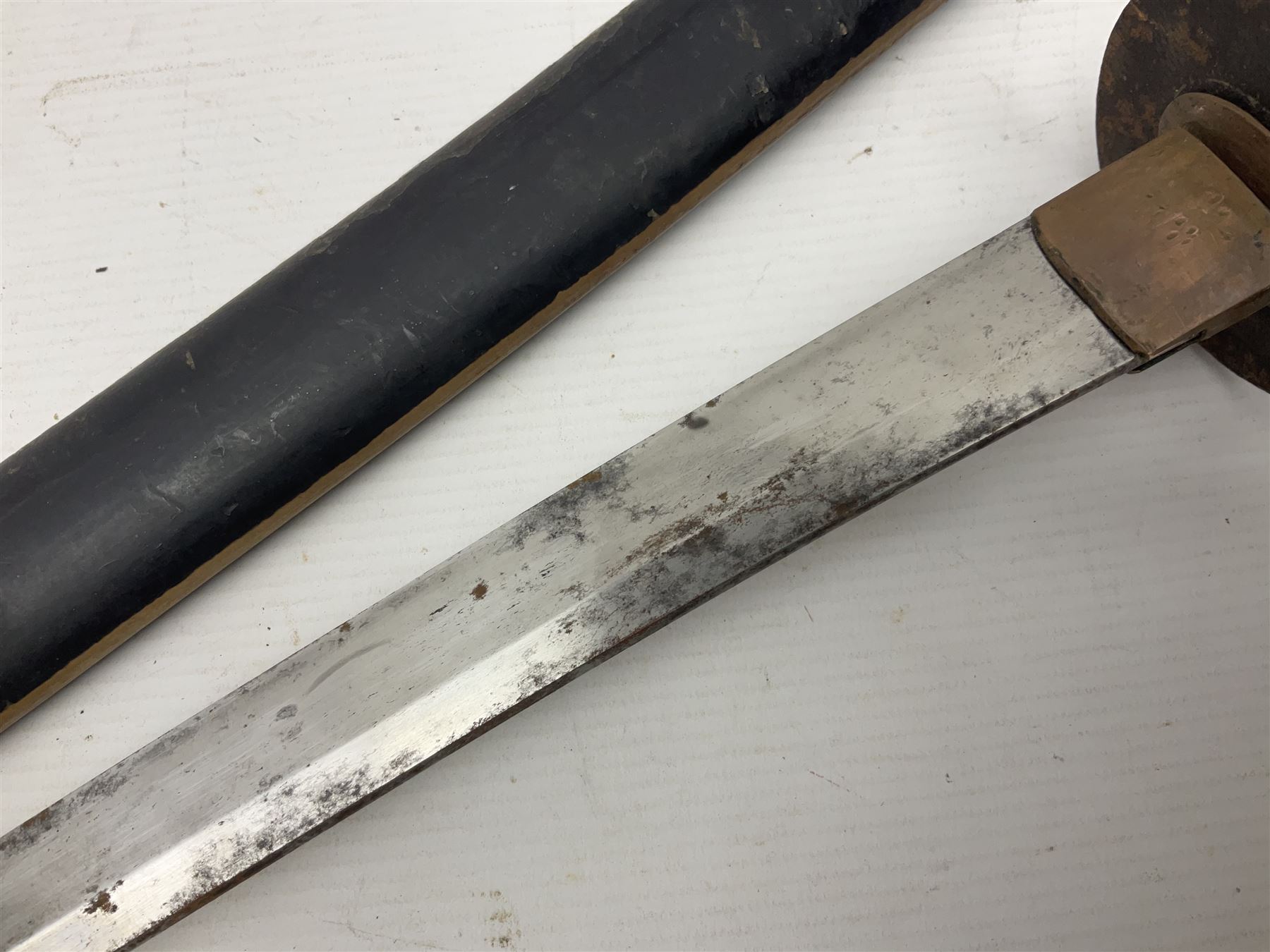 Good quality Japanese sword blade with later WWII fittings and scabbard  - 67.5cm slightly curving blade with unmarked tang, plain iron tsuba and lacquered grip with copper mounts; in lacquered wooden scabbard with tape bound tip L94cm overall