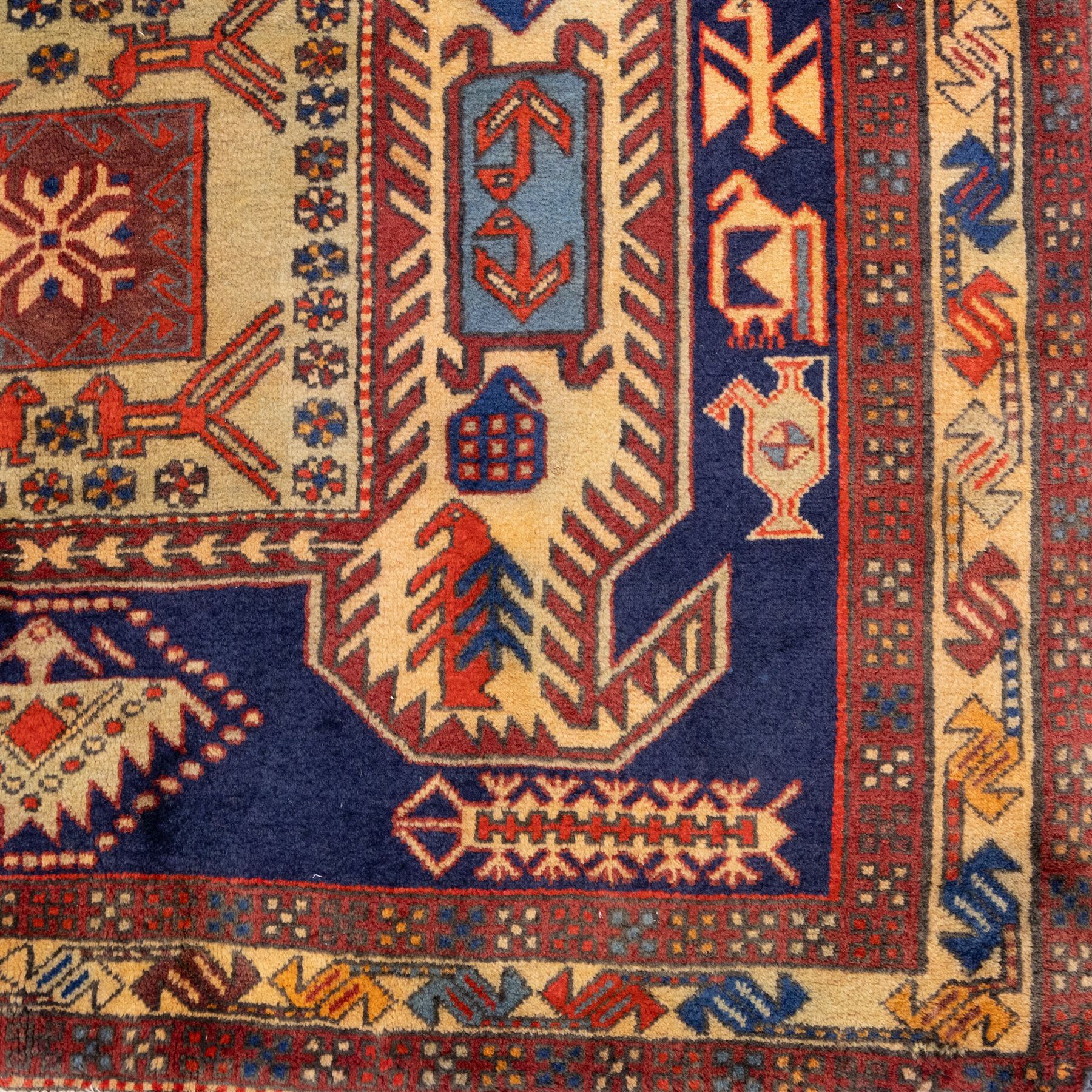 North West Persian Ardebil hand-knotted runner, indigo blue field composed of a repeating series of large stepped octagonal medallions enclosing a central hooked motif and stylized rosette, flanked by angular ivory and madder red latch hook devices, medallions linked by smaller geometric diamonds and serrated lozenges, guard borders with reciprocal motifs and main ivory border decorated with angular vines, with cotton fringe ends 
