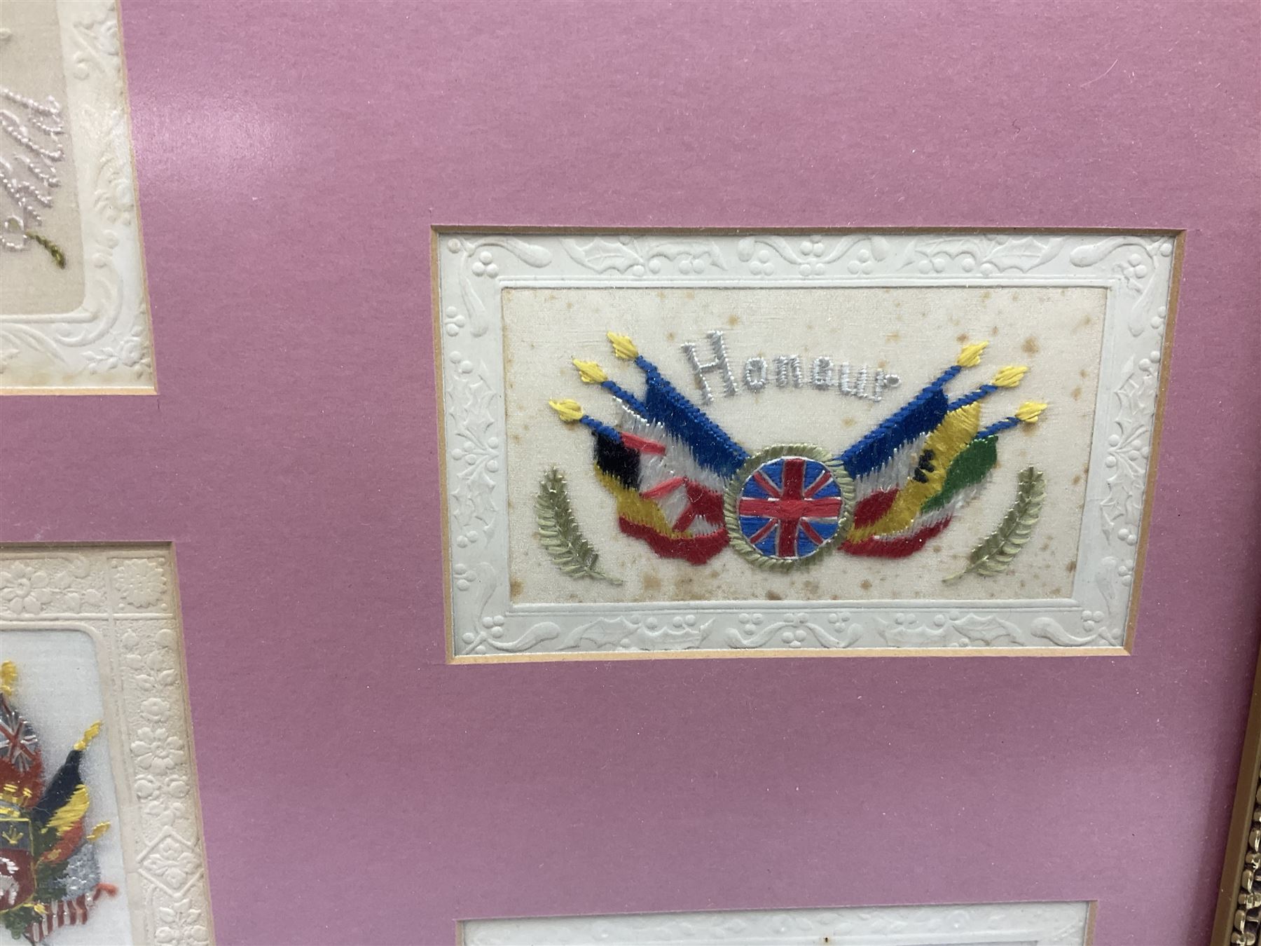 Thirty-five WW1 embroidered silk postcards including regimental crests, flags of the Allies, envelope type with greeting card inserts, Christmas and birthday cards etc; mounted and glazed in three graduated modern matching gilt frames (3)