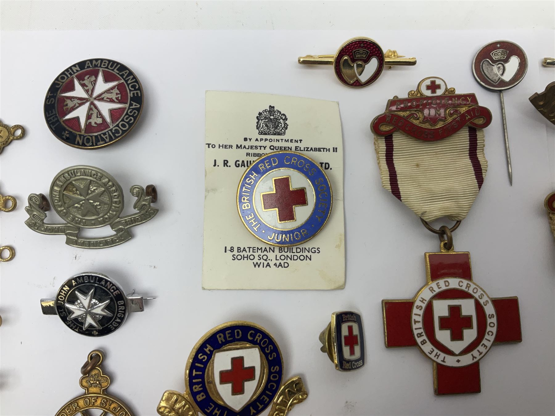 Collection of St John Ambulance enamel and metal badges, together with Red Cross medals and badges
