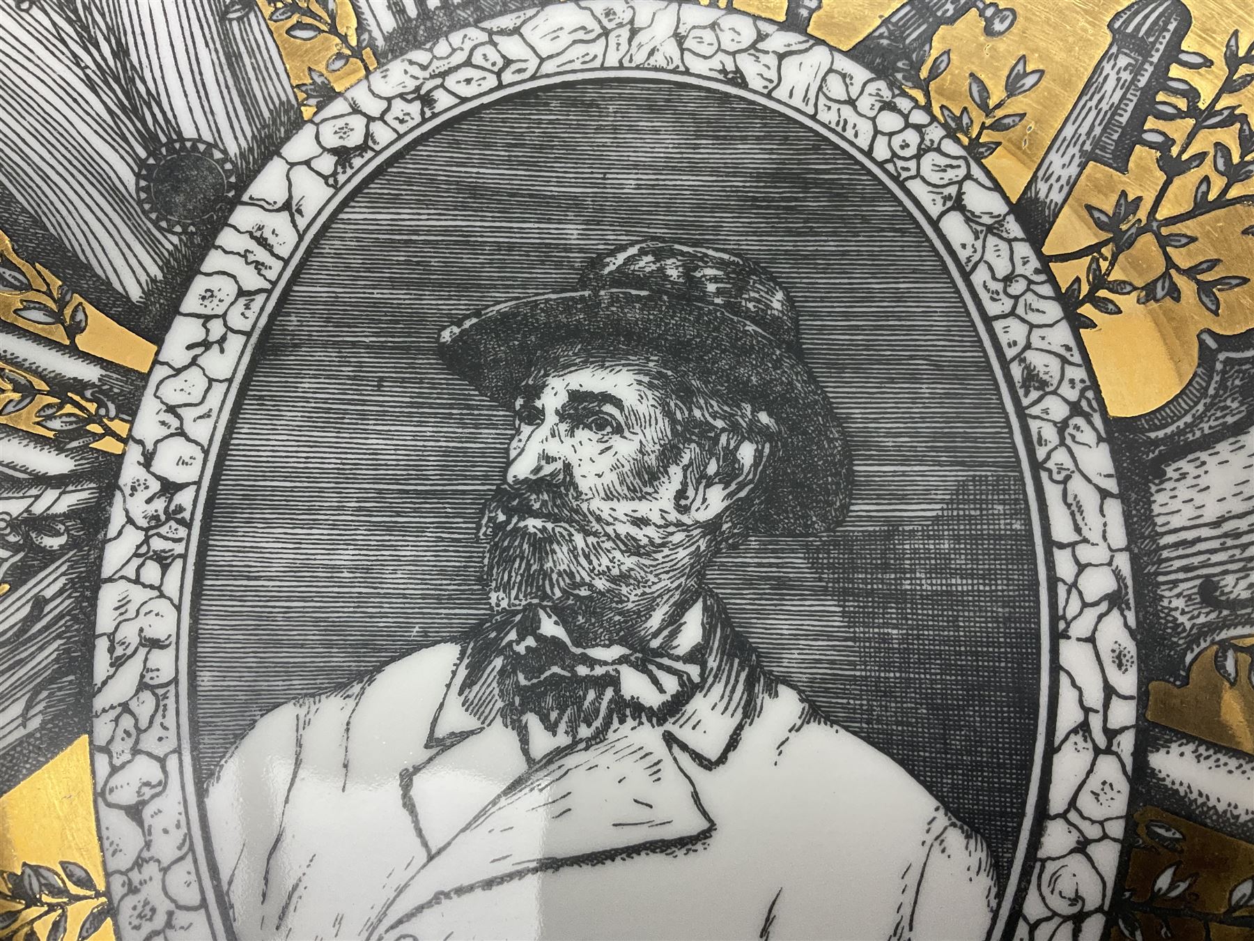 Fornasetti Grandi Maestri plate, depicting Giuseppe Verdi within a border of operatic emblems on gilt ground, with printed mark beneath, D25cm