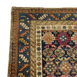 Small Caucasian rug or wall hanging, the indigo ground field decorated with geometric Gul motifs within multiple bands of geometric motifs