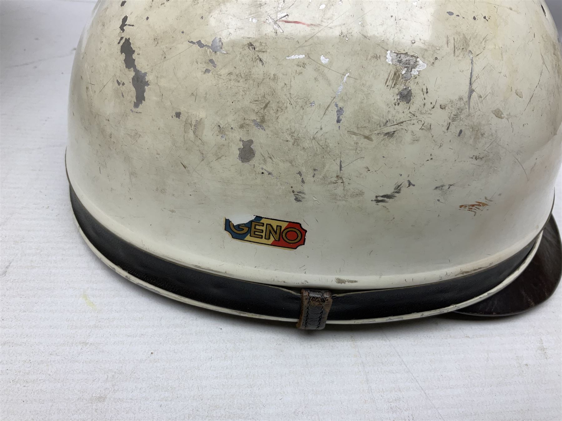 Two Geno Paris small size motorcycle helmets; and three pairs of goggles, one marked 'Stadium'