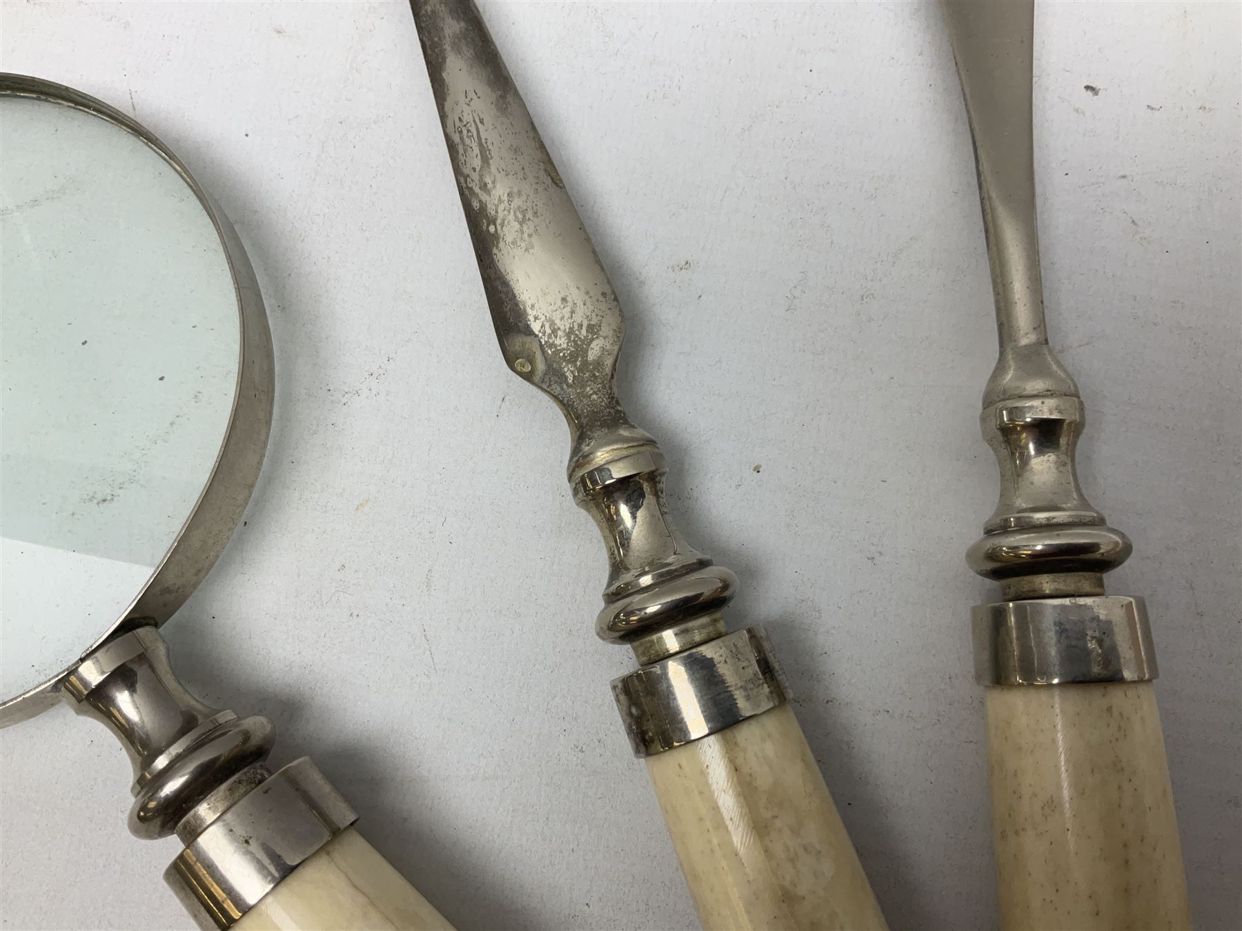 Magnifying glass, letter opener and shoe horn set, with bone handles and silver plated finials 