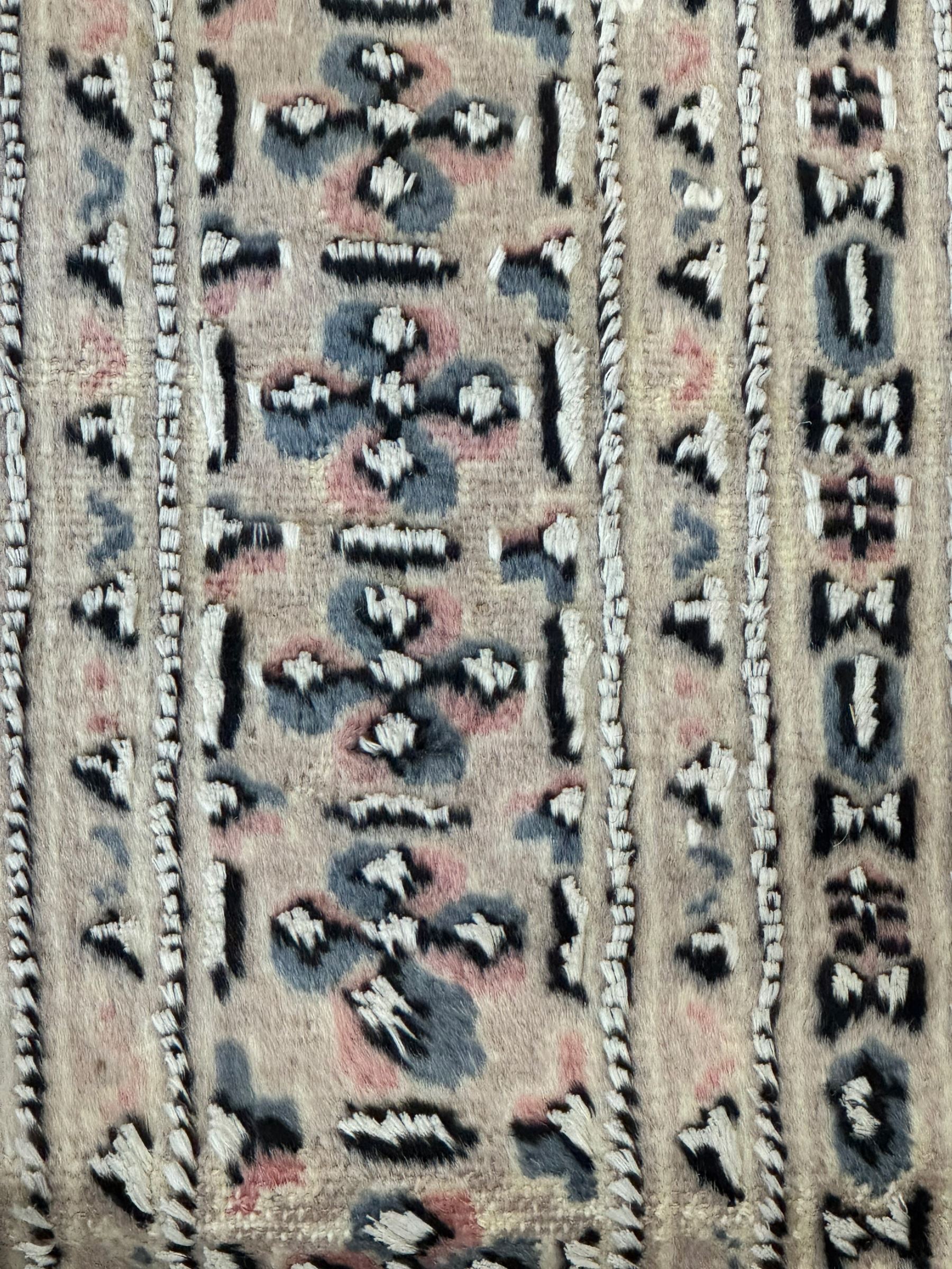 Persian design pale pink ground rug, the field divided into panels and decorated with Gul motifs, wide multi-band border with geometric patterns 