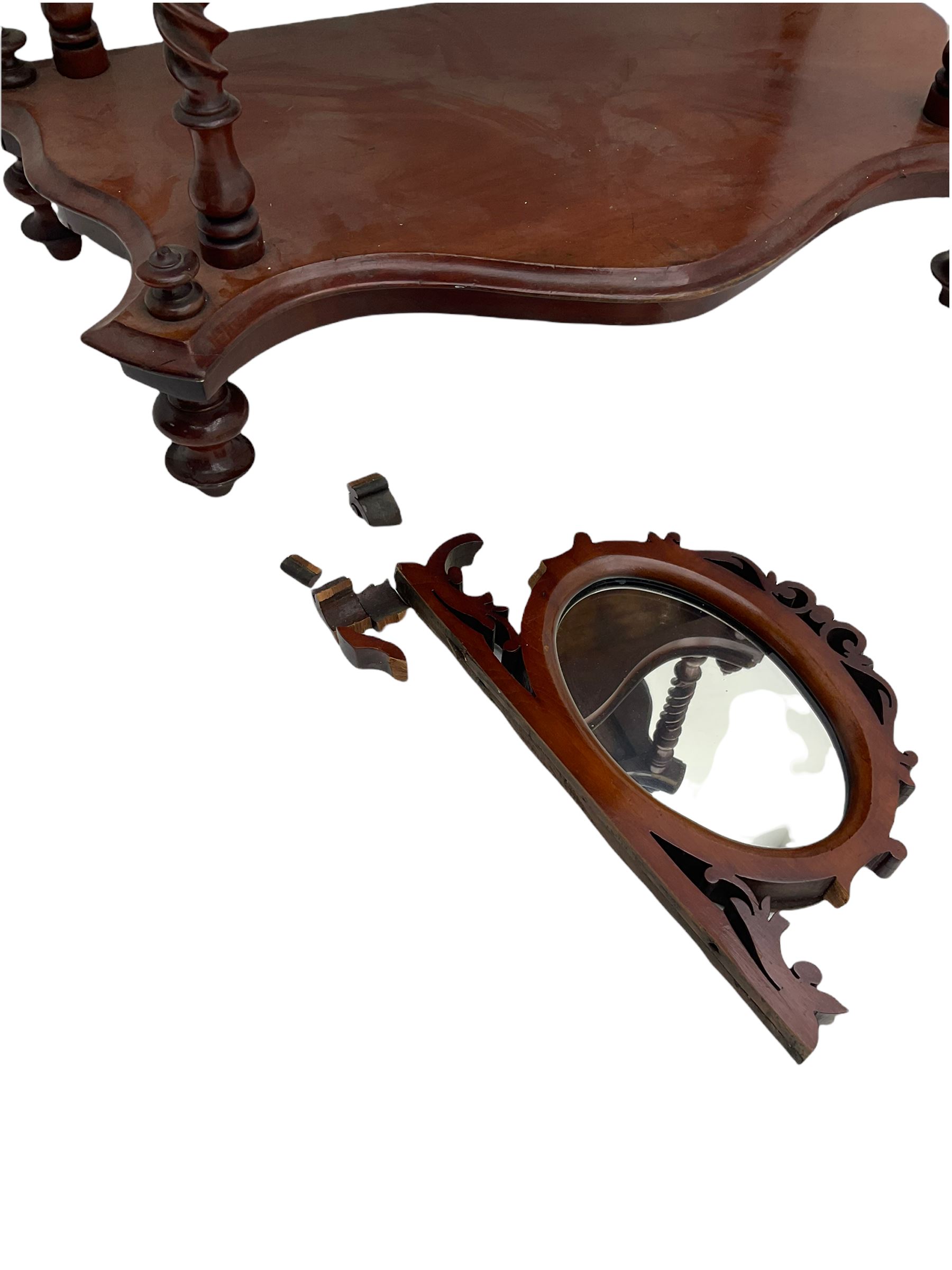 Victorian mahogany etagere, raised oval mirror in fretwork frame, four graduating shaped tiers, spiral turned supports