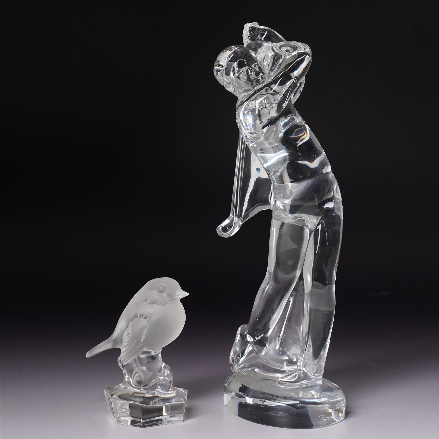 Baccarat figurine of a golfer, depicting a golfer in mid-swing, together with Nachtmann bird, golfer H24cm