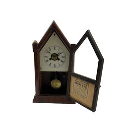 An American “Jerome” late 19th century  30-hour spring driven steeple clock with alarm, in a mahogany case with a decorative glass tablet depicting a rose painted white dial with roman numerals and minute track, steel moon hands and a brass alarm setting disc to the centre. With pendulum and key.
H40 W20 D10
With a small portable 19th century German “Wutternberg” alarm clock, the piece dial with a gilt centre and Ivorine chapter ring, Arabic hours and minute band, wooden case with brass fittings and carrying handle on four feet, wound and set from the rear with integral keys, alarm sounding on a bell. 
H20 W12 D7
