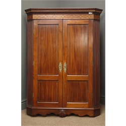  Early 20th century mahogany, inlaid, wall hanging corner cabinet, projecting cornice, two panelled doors, fluted sides, shaped apron with carved shell, W84cm, L122cm, D50cm  