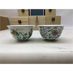 Two Chinese Yixing teapots, Chinese tea bowl hand painted with figures reading, another tea bowl with with underglaze floral panel and another tea bowl with saucer and lid, together with other teacups etc all boxed and with character marks