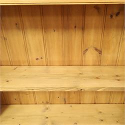 Traditional large pine bookcase, moulded cornice above five adjustable shelves