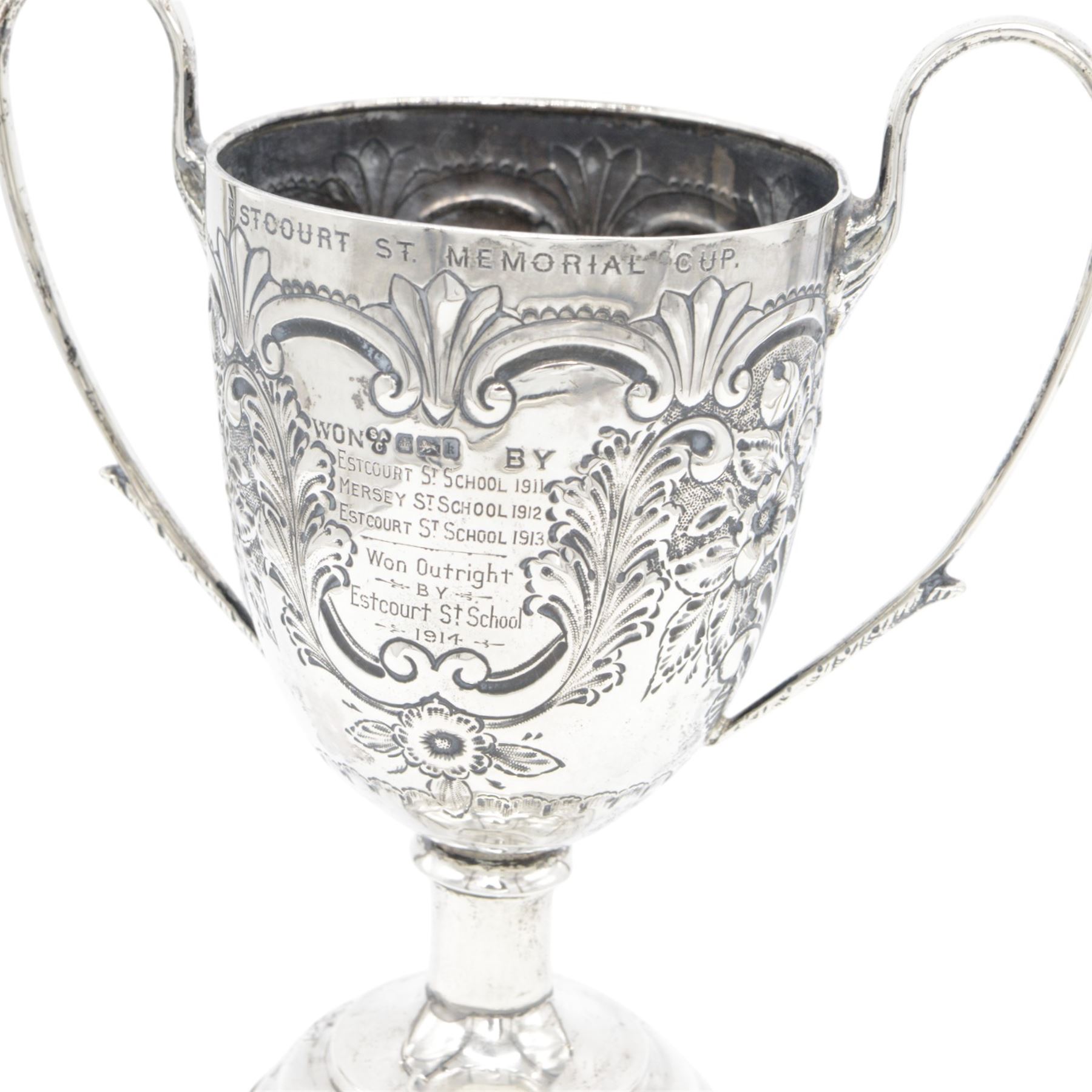 Edwardian silver twin handled trophy, engraved with presentation engraving and embossed with floral and foliate decoration to body, upon a domed circular weighted base, hallmarked 	Hammond, Creake & Co (Saint Arnaud Creake), Sheffield 1902, H22cm