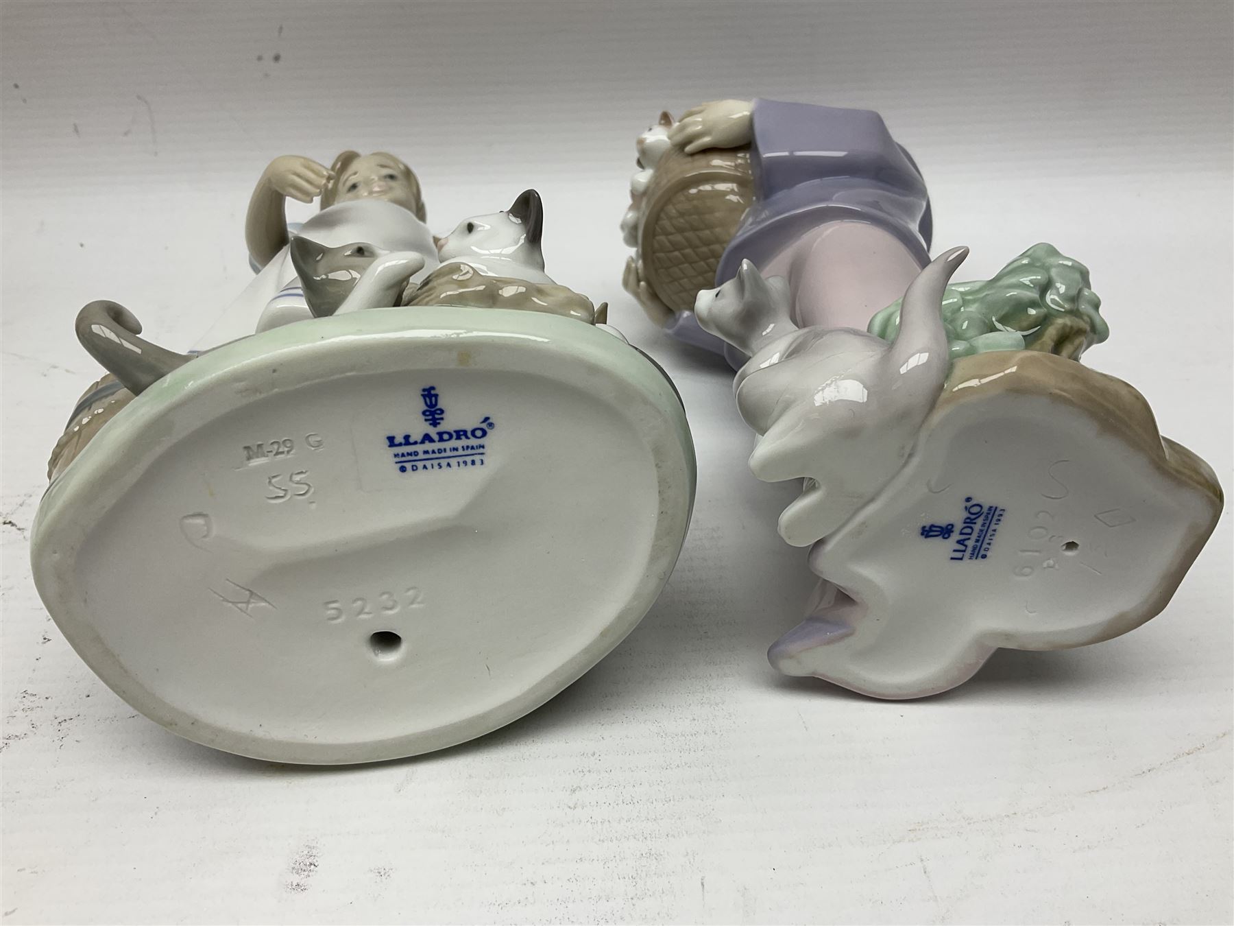 Five Lladro figures, including The Lamp Lighter no 5205,  Girl and Kittens no 6102, Cat no 5113 etc