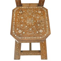 19th century Syrian olive wood and ivory inlaid chair, the shaped back and cresting above a panel centred by a circular starburst roundel within geometric and foliate marquetry and stringing, the tapering uprights and frame extensively inlaid with repeating ivory motifs, the octagonal seat similarly decorated, raised on splayed legs united by H-stretcher with further inlaid ornament