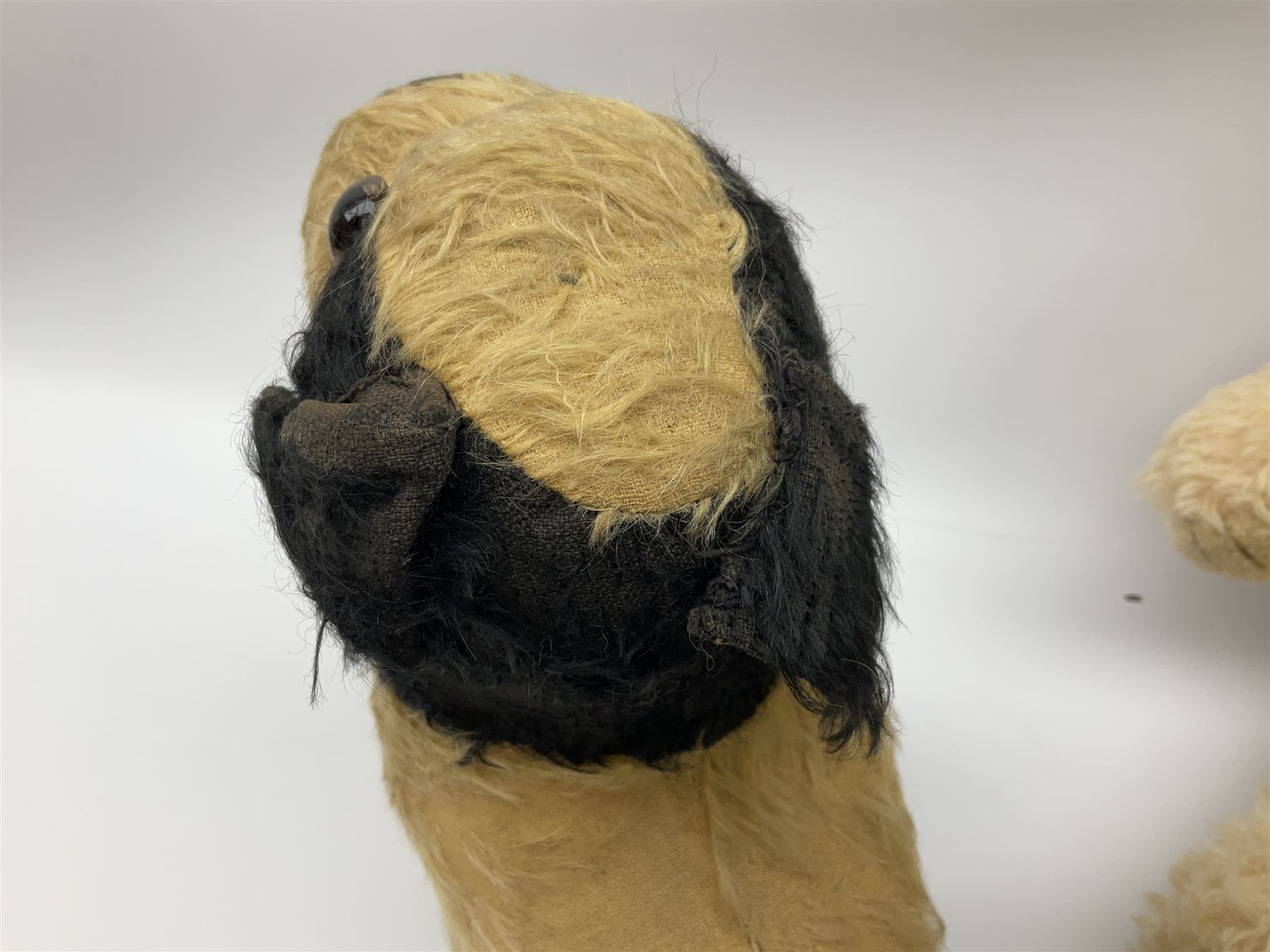 Mid-20th century English plush covered woodwool filled dog with vertically stitched nose and mouth L39cm; and Wendy Boston plush covered teddy bear, the fixed head with applied eyes and vertically stitched nose and mouth H63cm (2)