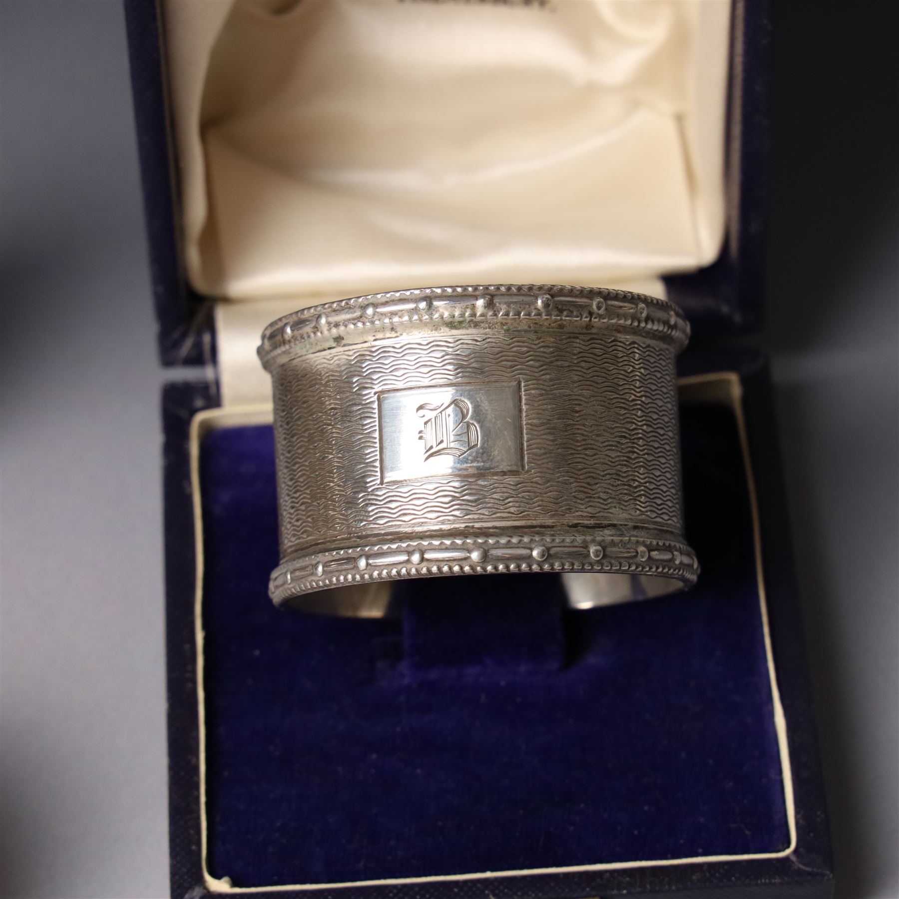 Silver three piece condiment set Birmingham 1938, pair of silver napkin rings, cased, plated napkin ring, silver money clip and silver thimble