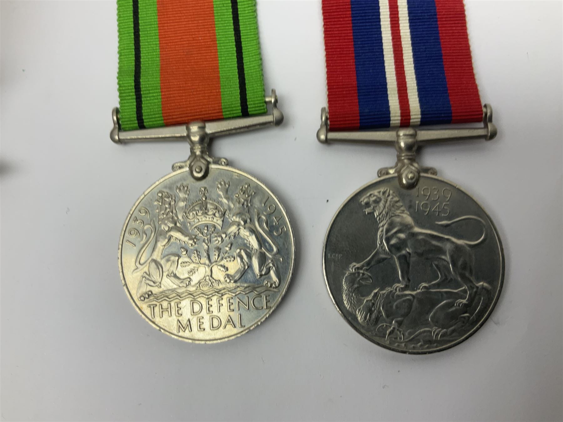 WWI pair of medals comprising British War Medal and Victory Medal awarded to 32682 Pte. W. Meadows W. Rid. R. in issue box; WWI pair of medals comprising 1914-15 Star and Victory Medal awarded to 3720 Pte. (later Cpl.) E. Petty W. York. R. with issue letter from Tank Corps; WWII group of five medals comprising 1939-45 War Medal, Defence Medal and 1939-45, Italy and Africa Stars; all with ribbons; and book of nineteen seaman's Certificates of Discharge to cook Charles Filburn 1893 - 1901 from various British ports