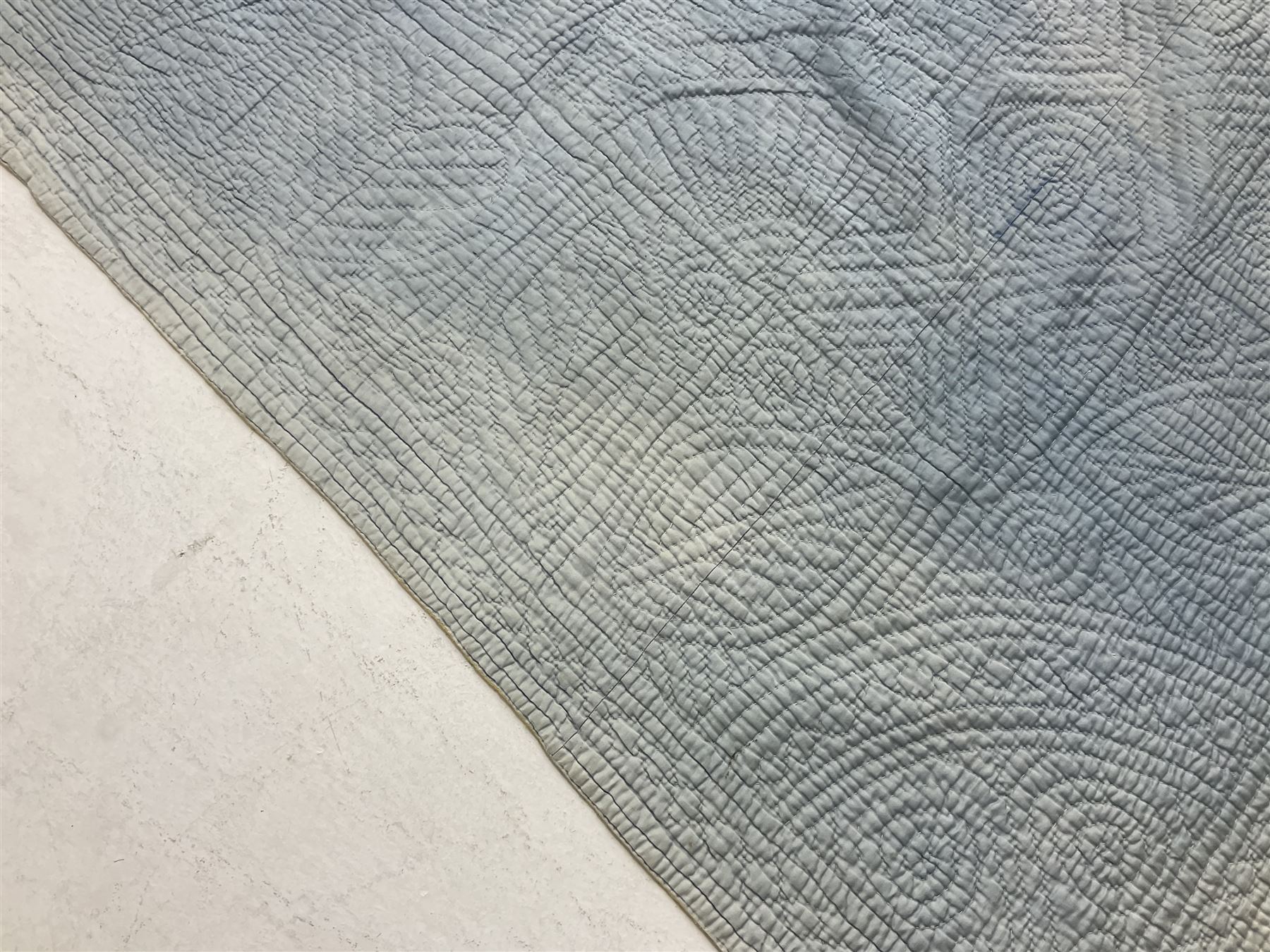 Early 20th century Welsh whole cloth sky blue quilt, in traditional quilting patterns, supported on yellow coloured backing, 174cm x 204cm