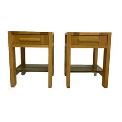 Pair of solid light oak lamp tables, fitted with single drawer and glass under-tier