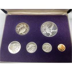 The Royal Mint United Kingdom 1977 silver proof two coin set, Queen Elizabeth II 2002 silver proof three coin set, comprising Bailiwick of Jersey, Bailiwick of Guernsey, and Alderney five pound coins, 'First Coinage of the British Virgin Islands' proof set, 1997 1/10 ounce fine silver Britannia, two King George V 1935 'Rocking Horse' crowns, various Isle of Man commemorative crowns, etc., house in a hard shell carry case
