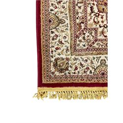 Persian design rug, red ground with central medallion, decorated with scrolling foliate 