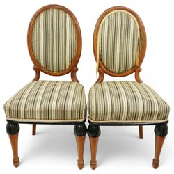 Mid-20th-century Biedermeier-style ebonized and satinwood pedestal table, quarter-veneered circular top with ebonized edge above a tapered baluster quarter-lobed column, raised on a circular plinth base, D87xH70cm, together with two matching upholstered spoon back chairs W45xD47xH87cm