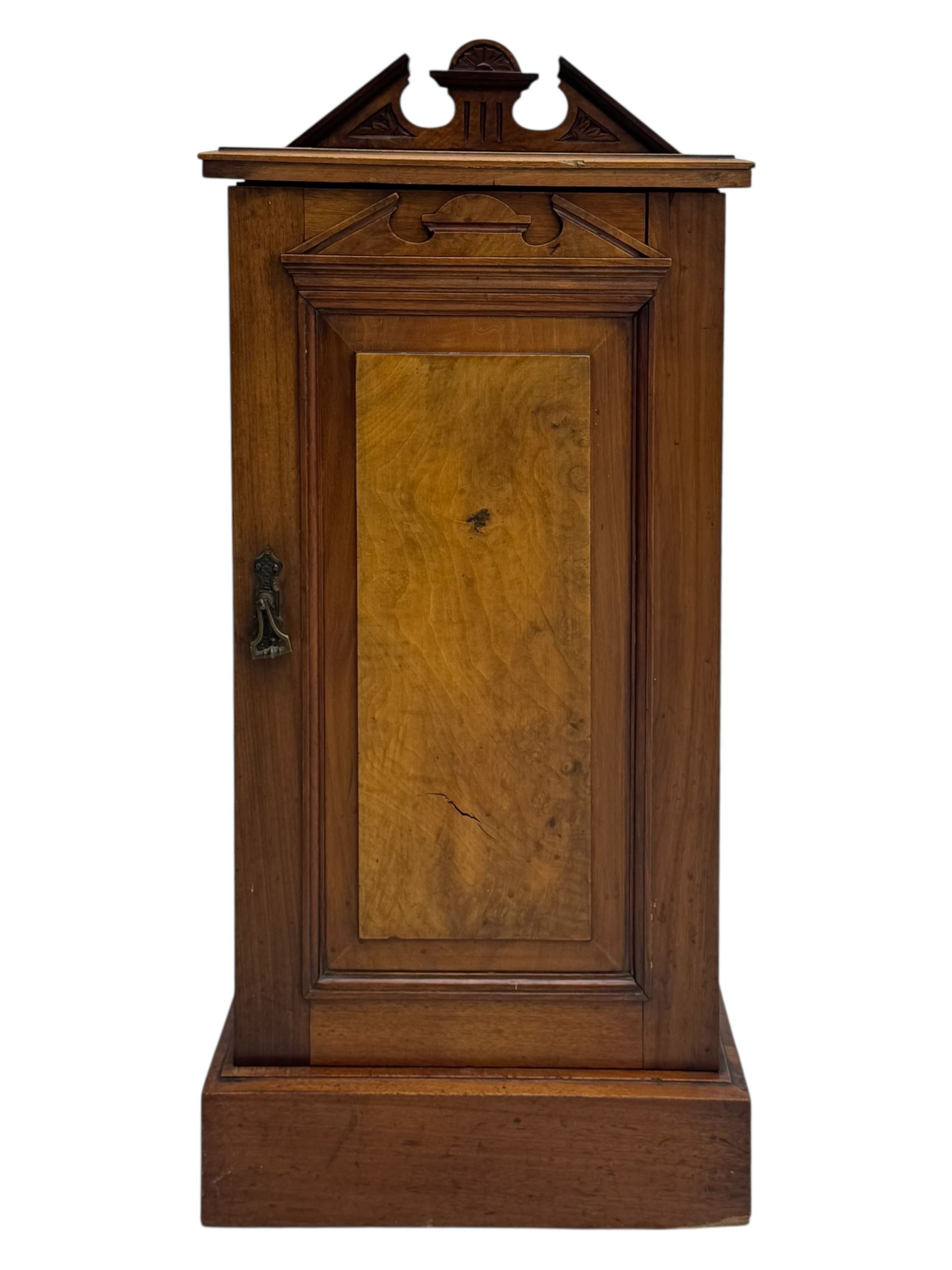 Victorian walnut bedroom suite - wardrobe, dressing chest and bedside cupboard, comprising a full-length wardrobe with broken pediment and central mirrored door, large lower drawer, a matching dressing table with bevelled swing mirror over two trinket drawers and two short drawers over two long drawers, and a single-door bedside cupboard, all with moulded edges, decorative panel work and shaped aprons