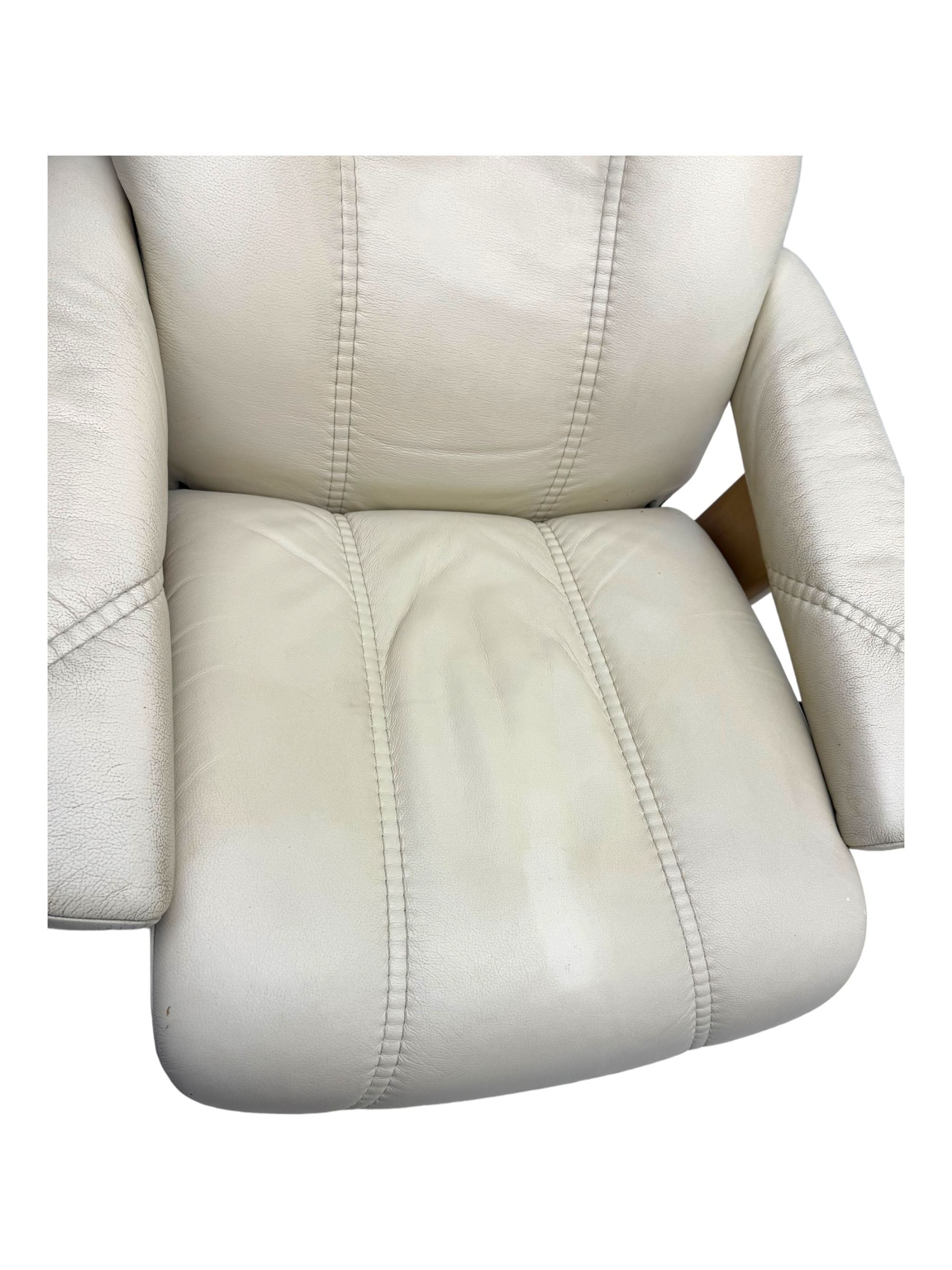 Ekornes Stressless - swivel and reclining armchair upholstered in cream leather, high back and padded armrests, raised on circular base