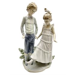 Lladro figure, One, Two, Three, modelled as a boy and girl with her foot raised, sculpted by Jose Roig, with original box, No 5426, date issued 1987 date retired 1995, H27cm
