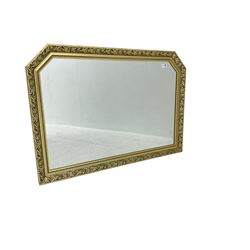 Gilt composition framed rectangular wall mirror with foliate mouldings and canted corners, 103x72cm