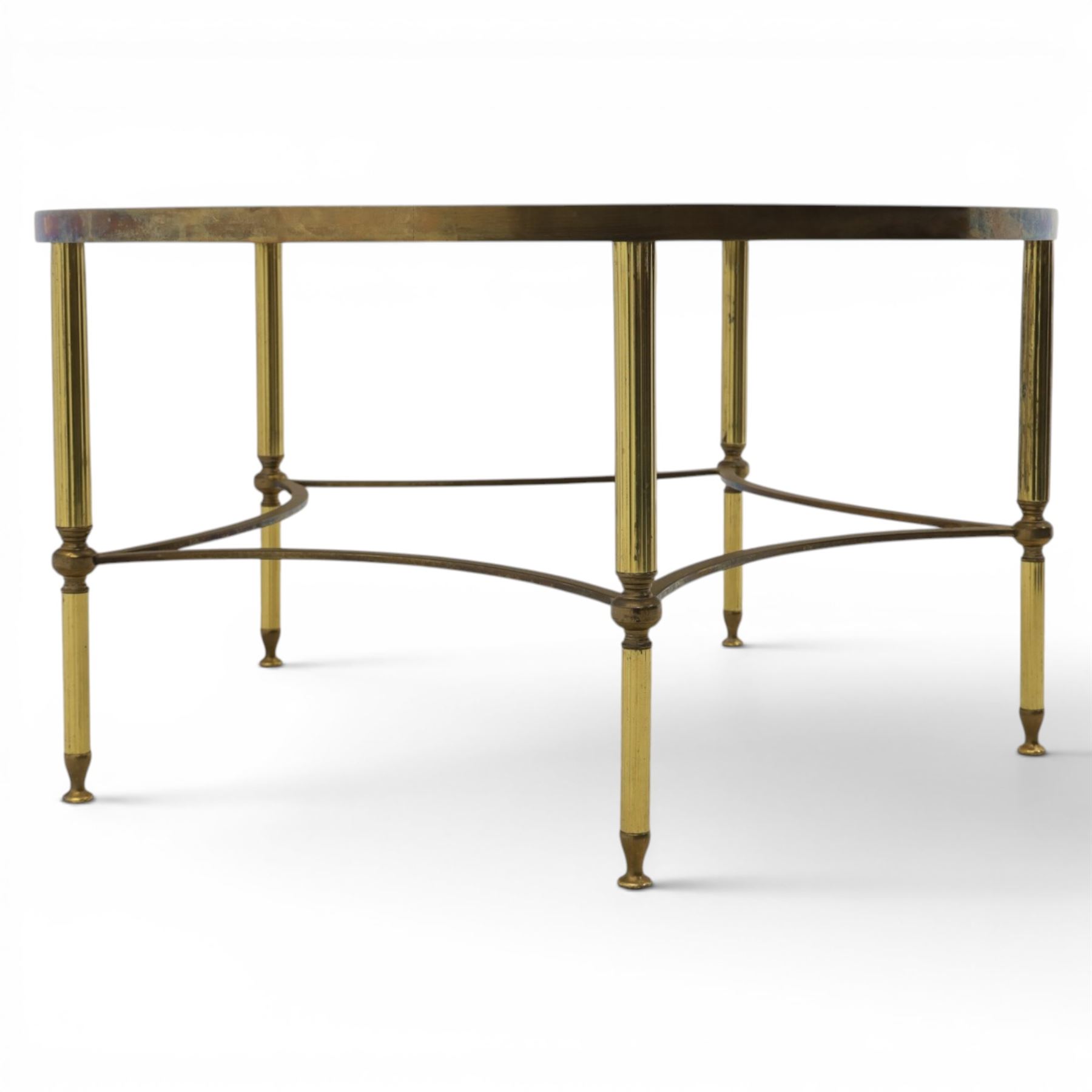 Regency style brass and glass circular table, smoked glass top mounted to a brass frame with fluted supports united by stretchers