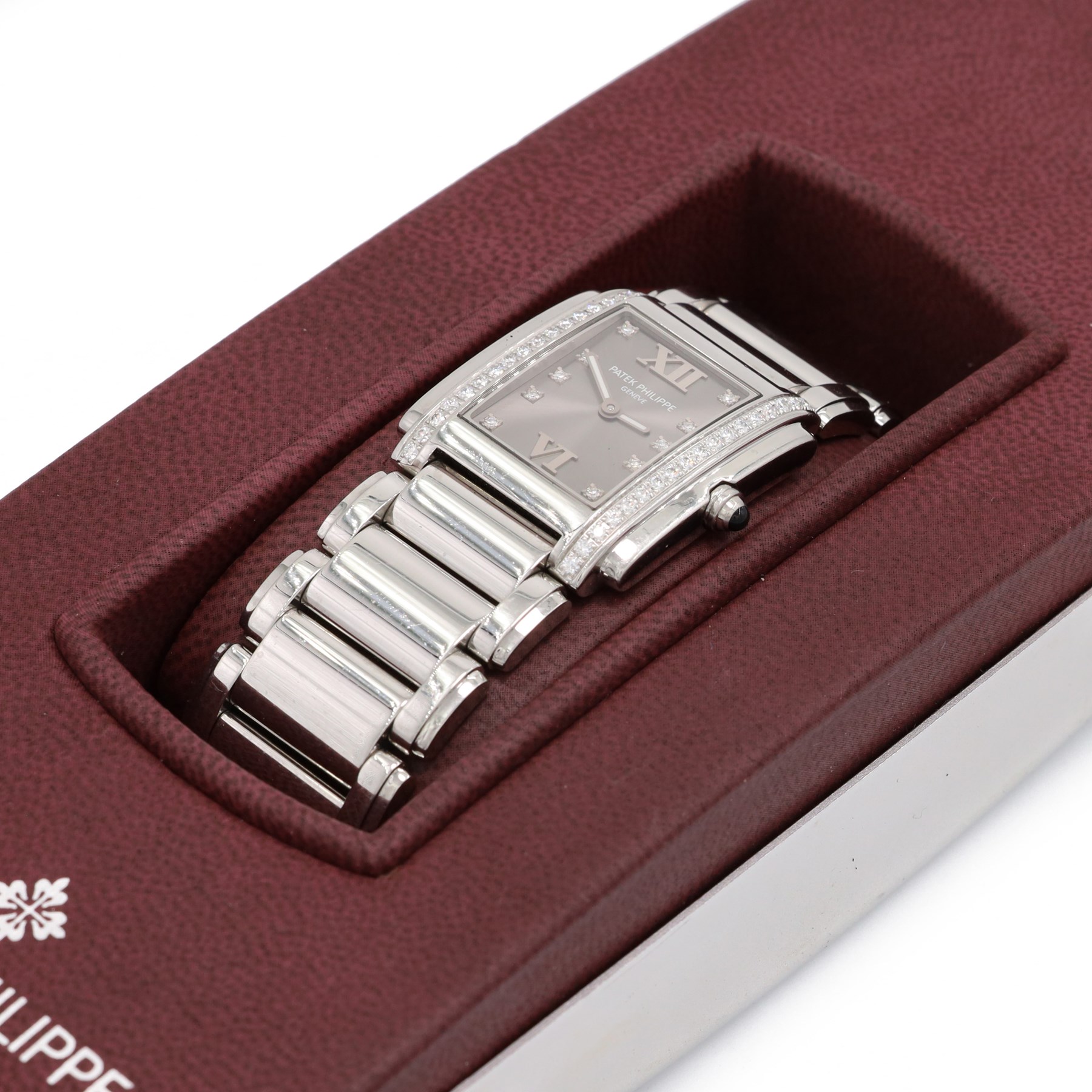 Patek Philippe Twenty~4 ladies stainless steel quartz wristwatch, sunburst grey dial with Roman numeral and diamond dot hour markers and diamond set case, on original bracelet, with fold-over clasp boxed
