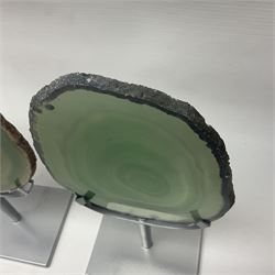 Pair of green agate slices, polished with rough edges raised upon silvered metal stands, H19cm