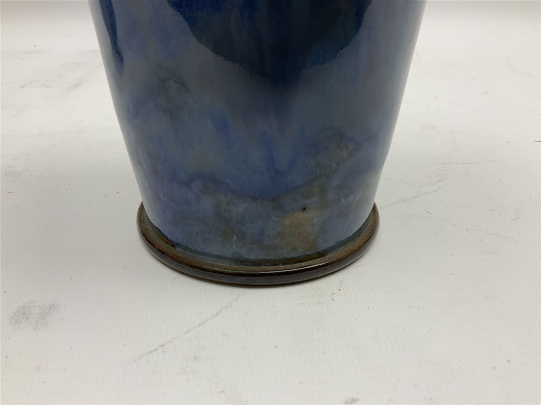 Two Royal Doulton stoneware vases, the first example with tubelined floral decoration, the second with Art Nouveau decoration, together Doulton Lambeth vase of flattened form with foliate decoration on a green ground, all with impressed mark beneath, tallest example H26cm