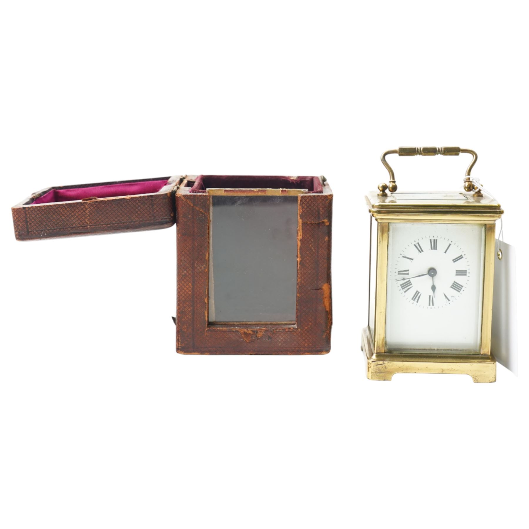 Two early 20th century 8-day French Carriage clocks- one with its original traveling case, lever platform escapement, enamel dial and Roman numerals, the other with a cylinder platform escapement, enamel dial with Roman numerals and five minute Arabic's.  