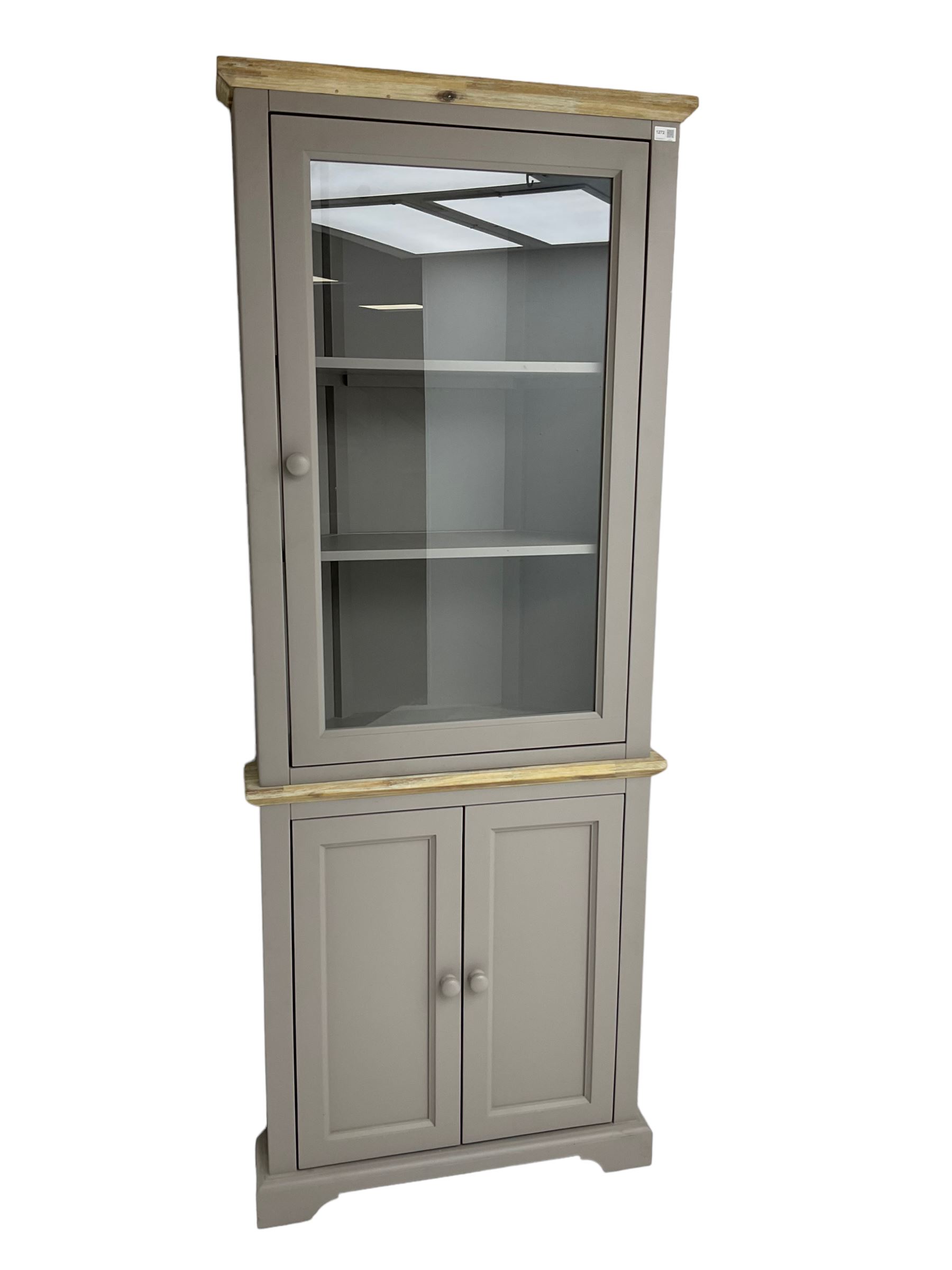 Contemporary teal and oak finish corner cabinet, single glazed door enclosing two shelves, over two panelled cupboard doors