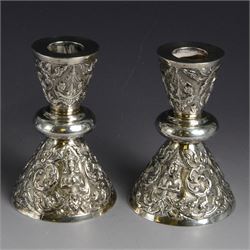 Pair of Thai silver candlesticks, of tapering conical form with knopped stems, embossed wi...