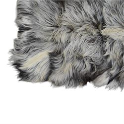 Skins/Hides: cow hide with brown and white dappled pattern together with another hide, possibly Mongolian goat