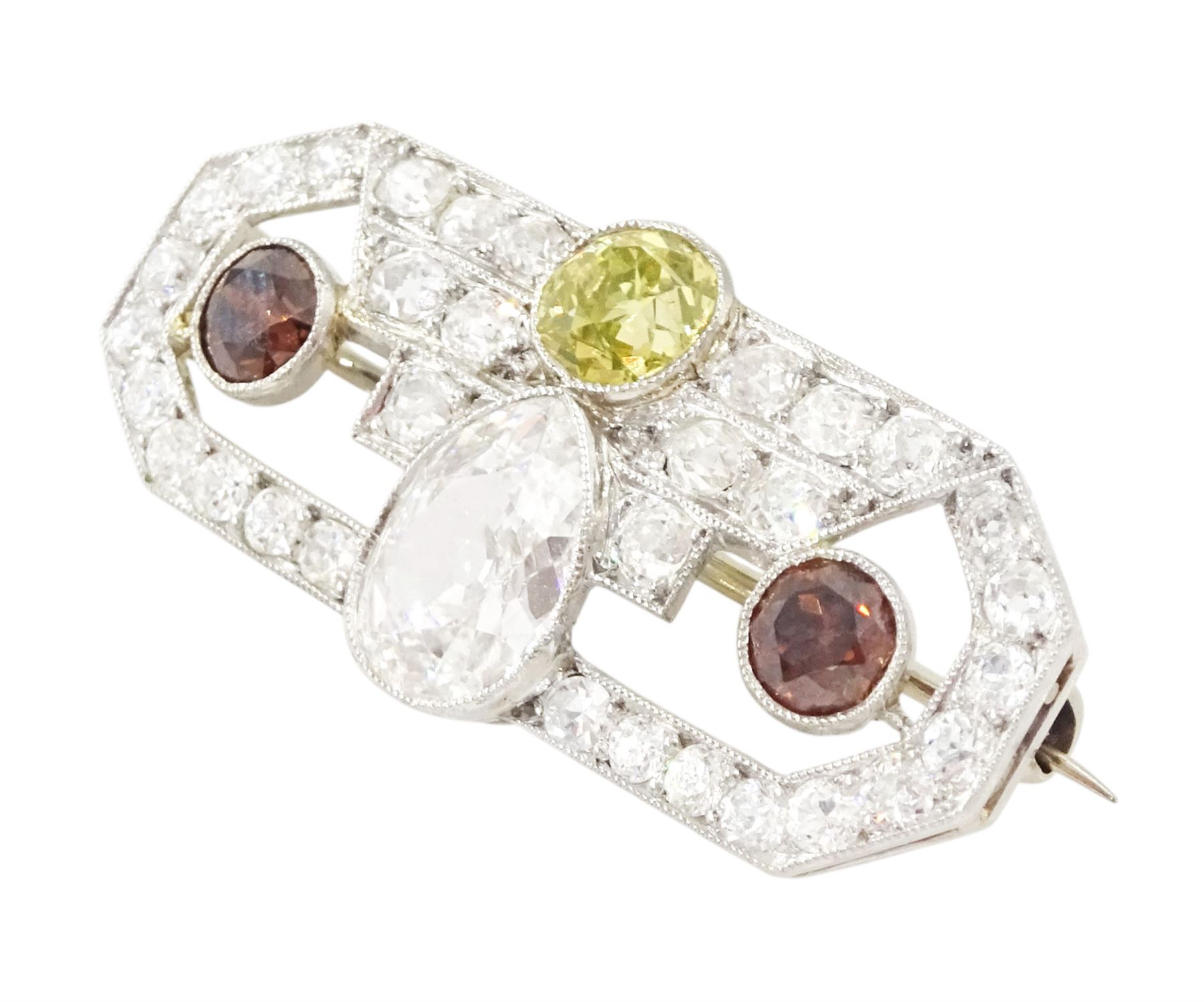 Early 20th century platinum diamond brooch, milgrain set with a pear cut faint brown diamond of approx 1.50 carat, an old cut fancy yellow / green diamond of approx 0.70 carat, and two old cut fancy orange / brown diamonds of approx 0.40 carat and 0.35 carat, surrounded by old cut white diamonds in an openwork setting, total white diamond weight approx 1.45 carat