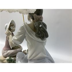 Lladro figure, As Pretty as a Flower Mother, modelled as a figure with 'lace' umbrella and dog at feet gesturing towards child with basket of flowers, upon a naturalistically modelled base with encrusted flower detail, H27cm