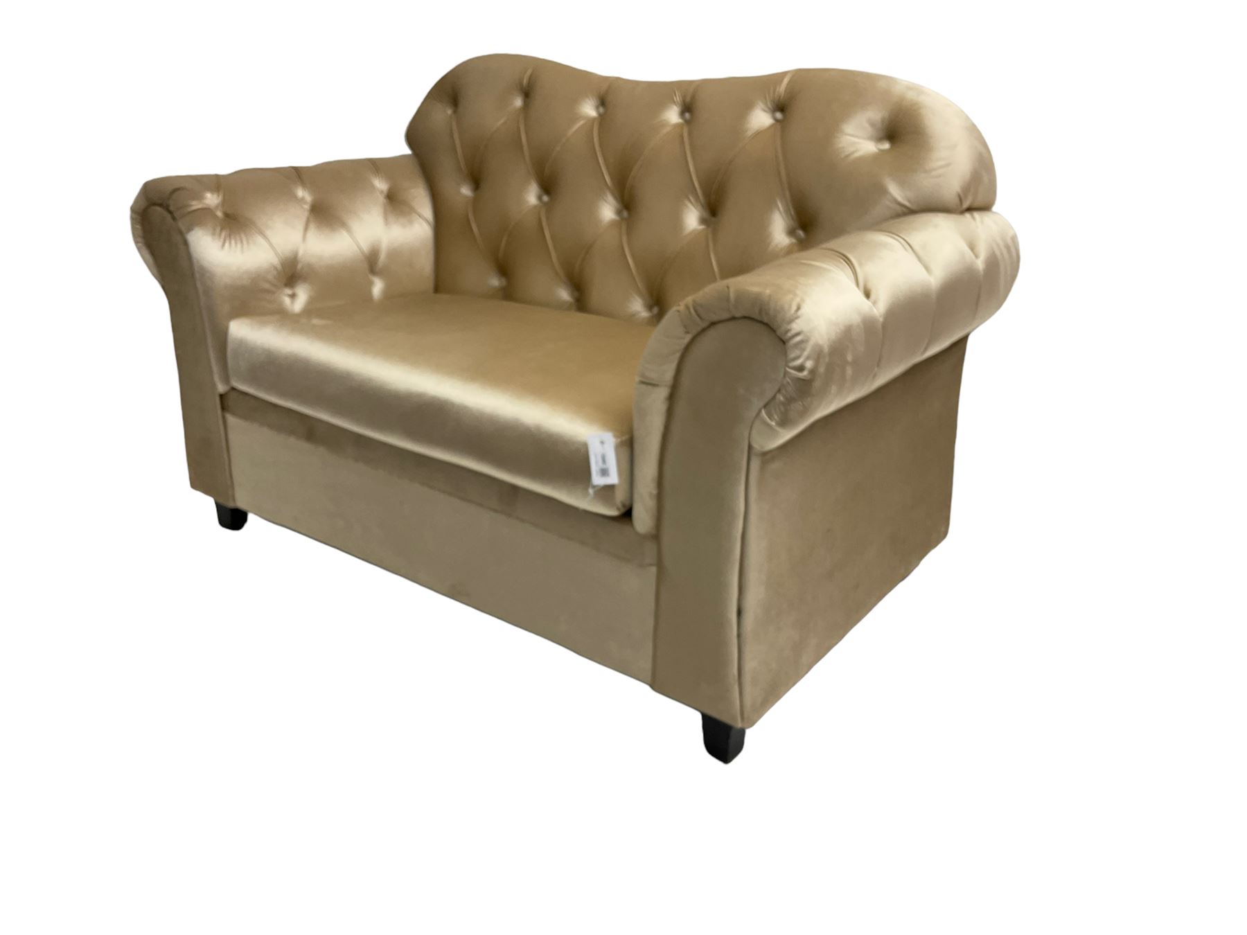 Chesterfield shaped snuggler sofa, upholstered in buttoned champagne fabric, with scatter cushions