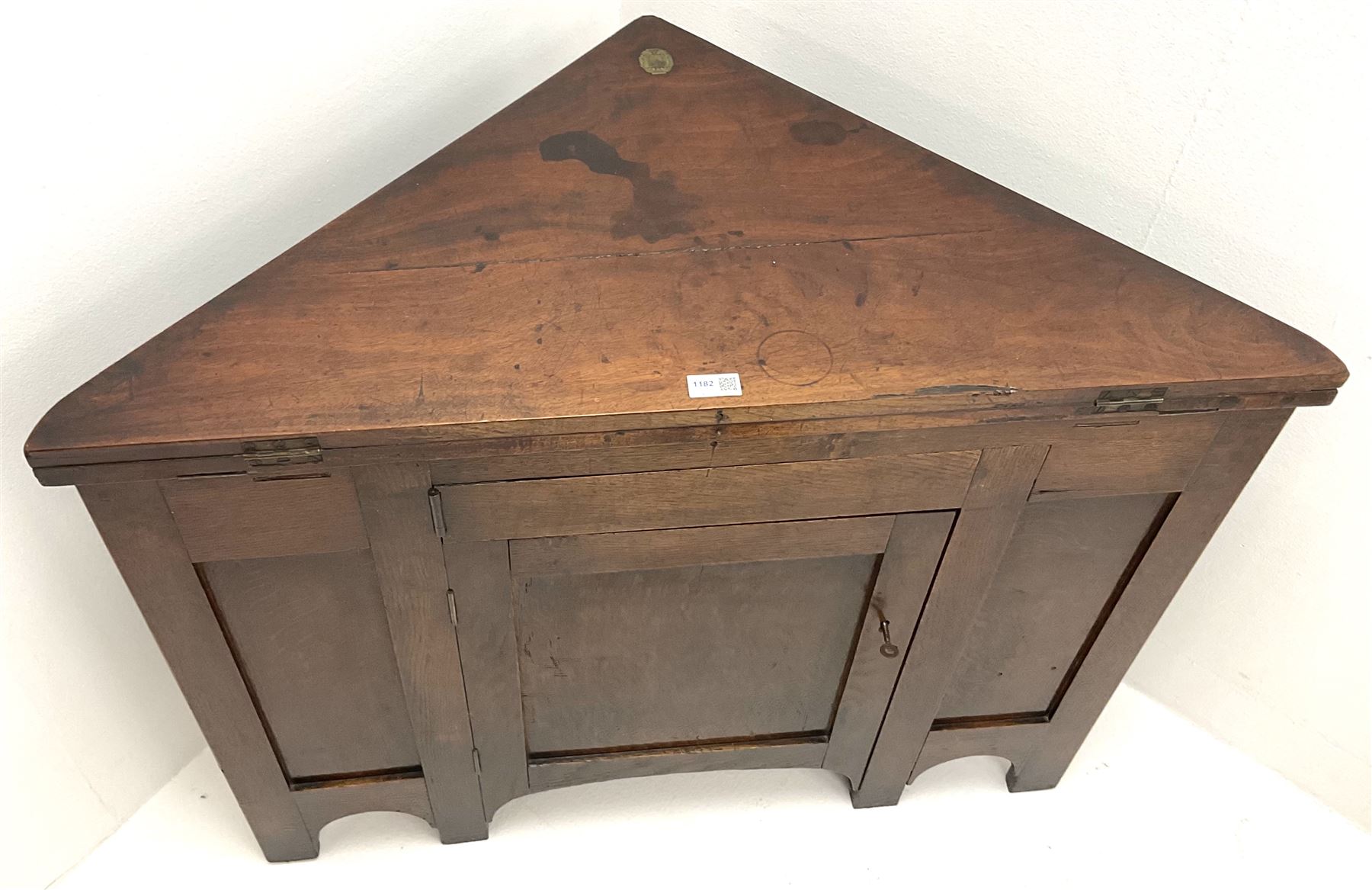 George III oak and mahogany corner campaign desk, single cupboard, folding top enclosing inset leather writing pad
