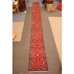  Kashan red ground runner, palmette floral scroll filled muticoloured field within repeating border, 756cm x 90cm  