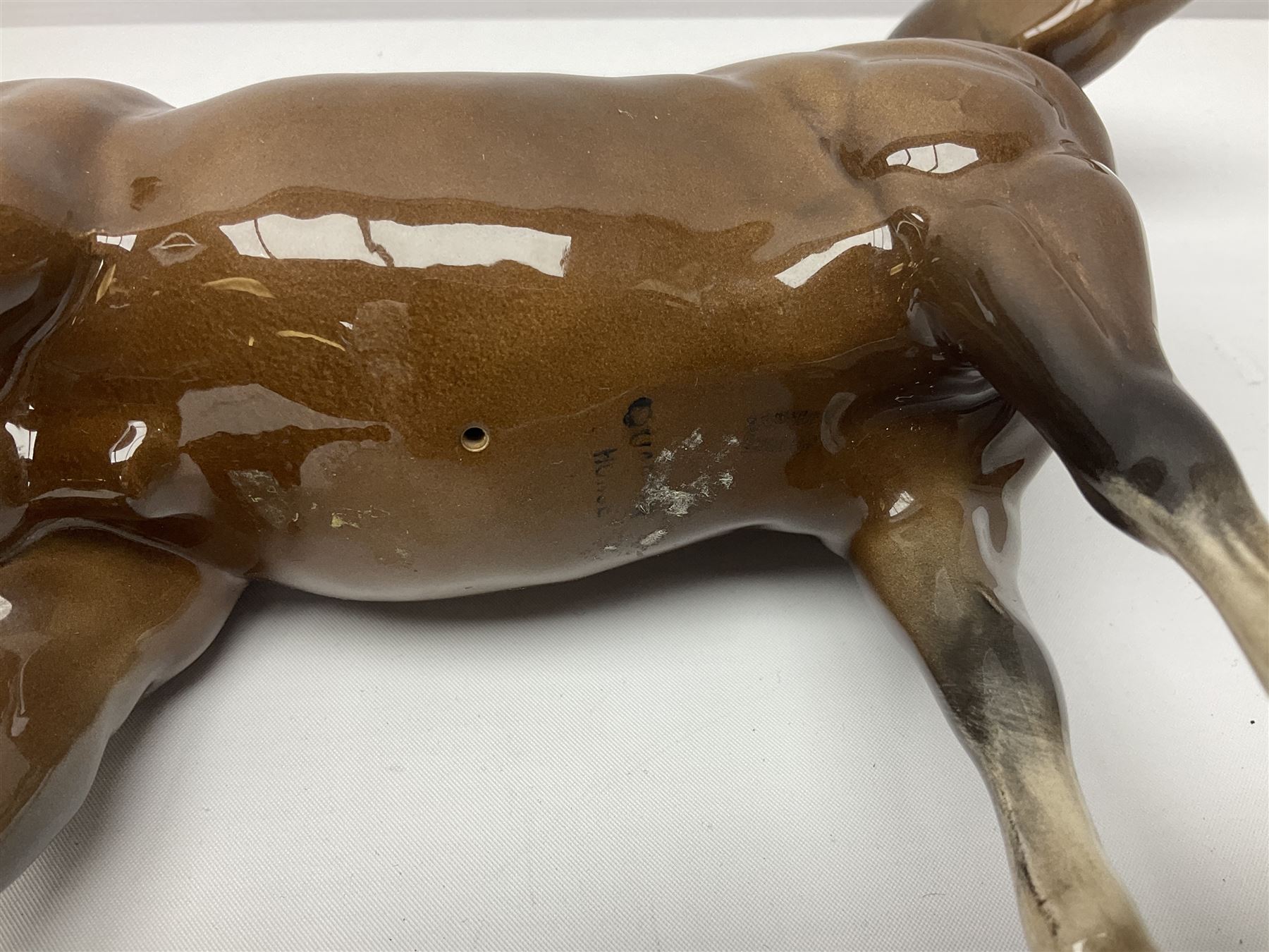Four Beswick horse figures, comprising Quarter Horse, two Shires no 818 and matt palomino, together with Beswick donkey and Royal Doulton horse on a wooden plinth  