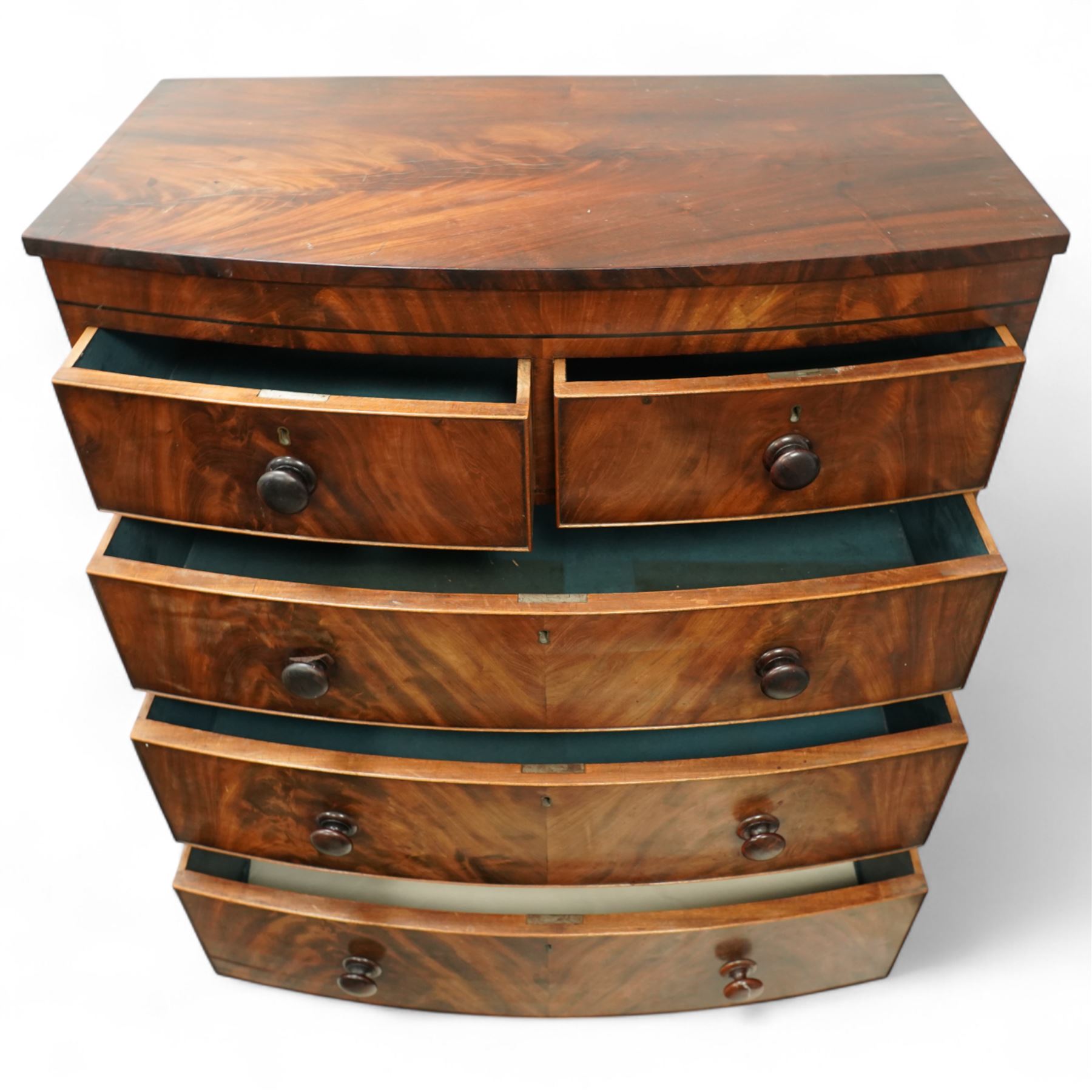 19th century mahogany chest of drawers, bow fronted form with two short over three long drawers, each veneered in matched flame mahogany, on turned feet