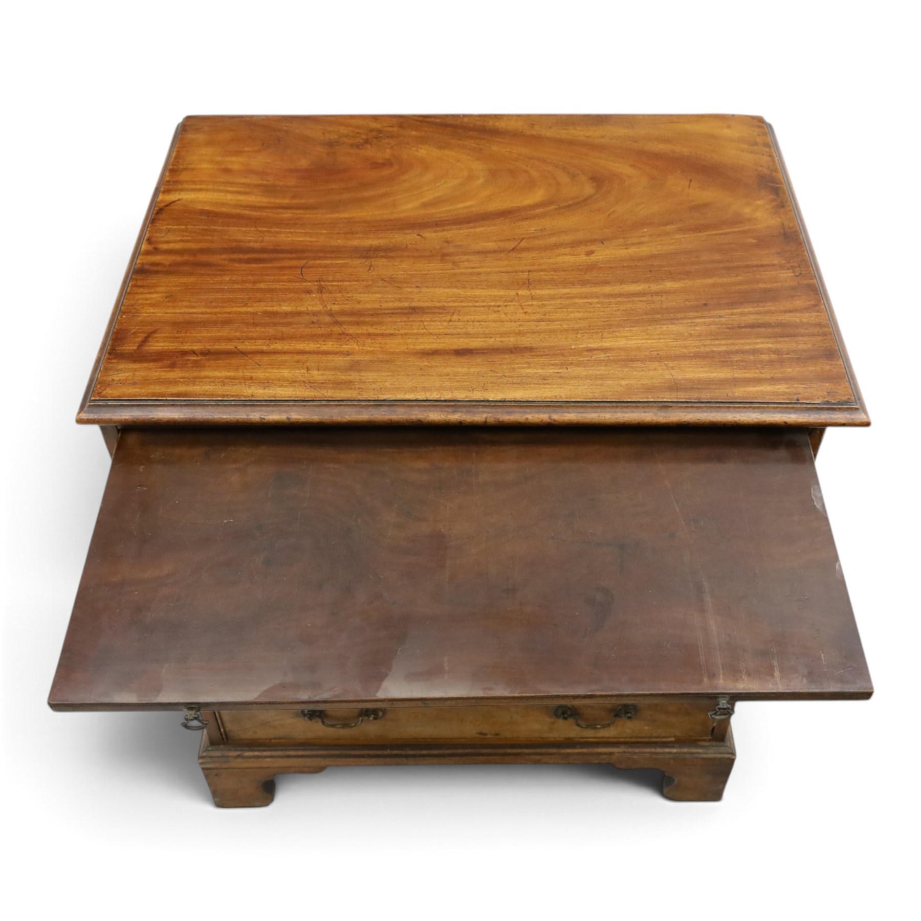 George III mahogany bachelors chest, rectangular top with moulded edge, fitted with brushing slide over two short and three long cock-beaded drawers with brass swan-neck handles, lower moulded edge on bracket feet